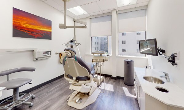 man smiling in dentists chair